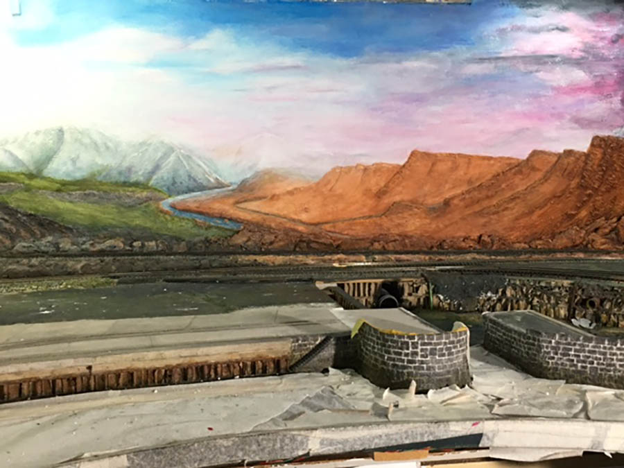 Paint clouds on model railroad backdrop