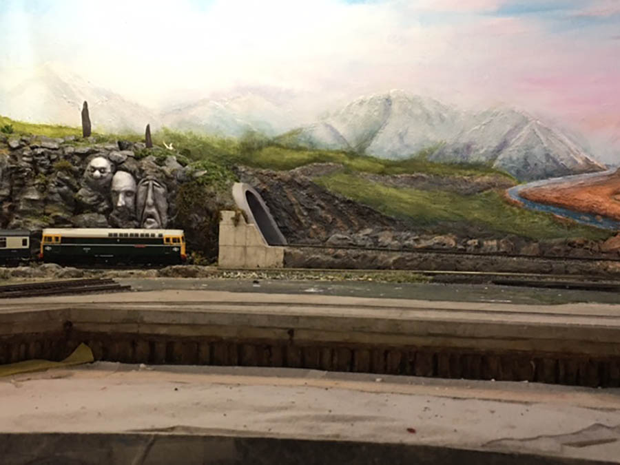 Paint clouds on model railroad backdrop