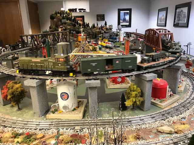 model train army locomotive with freight