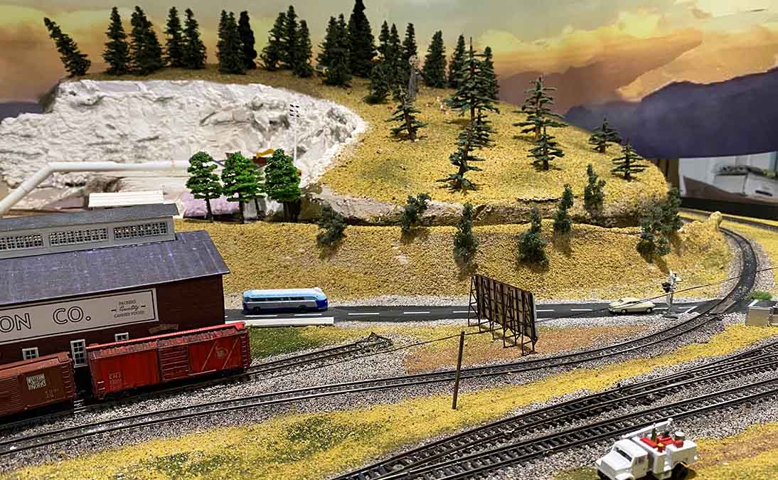 model railroad backdrop on hill