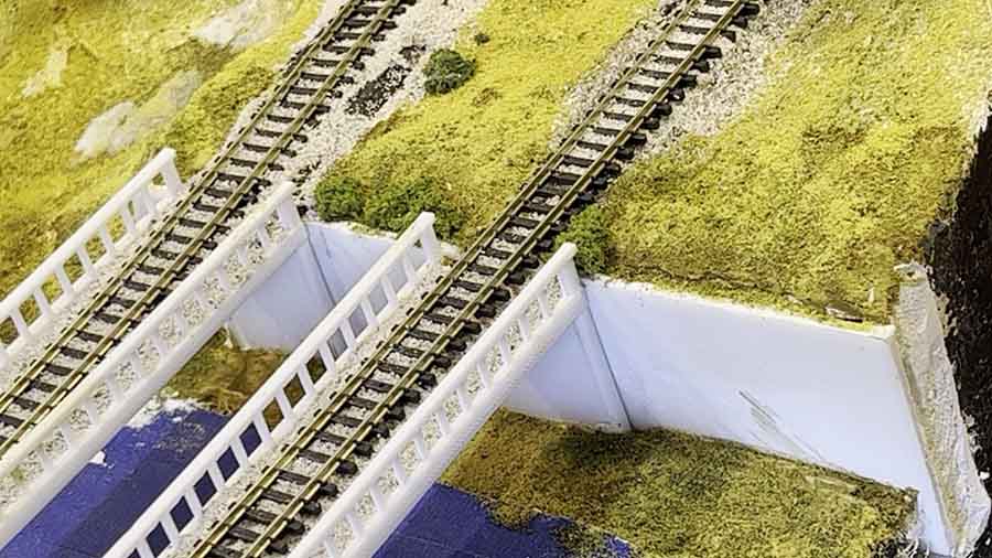 model train inclines grass embankment