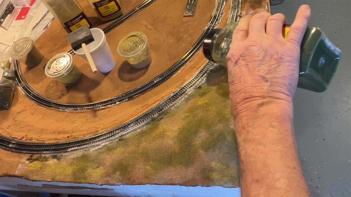 applying green to model train mountains