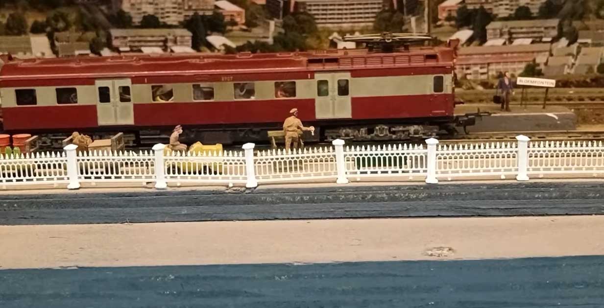 model train passenger car track side