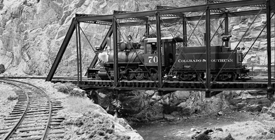 Battery power for model trains crossing truss bridge