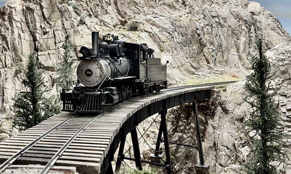 O scale steam engine on trestle bridge